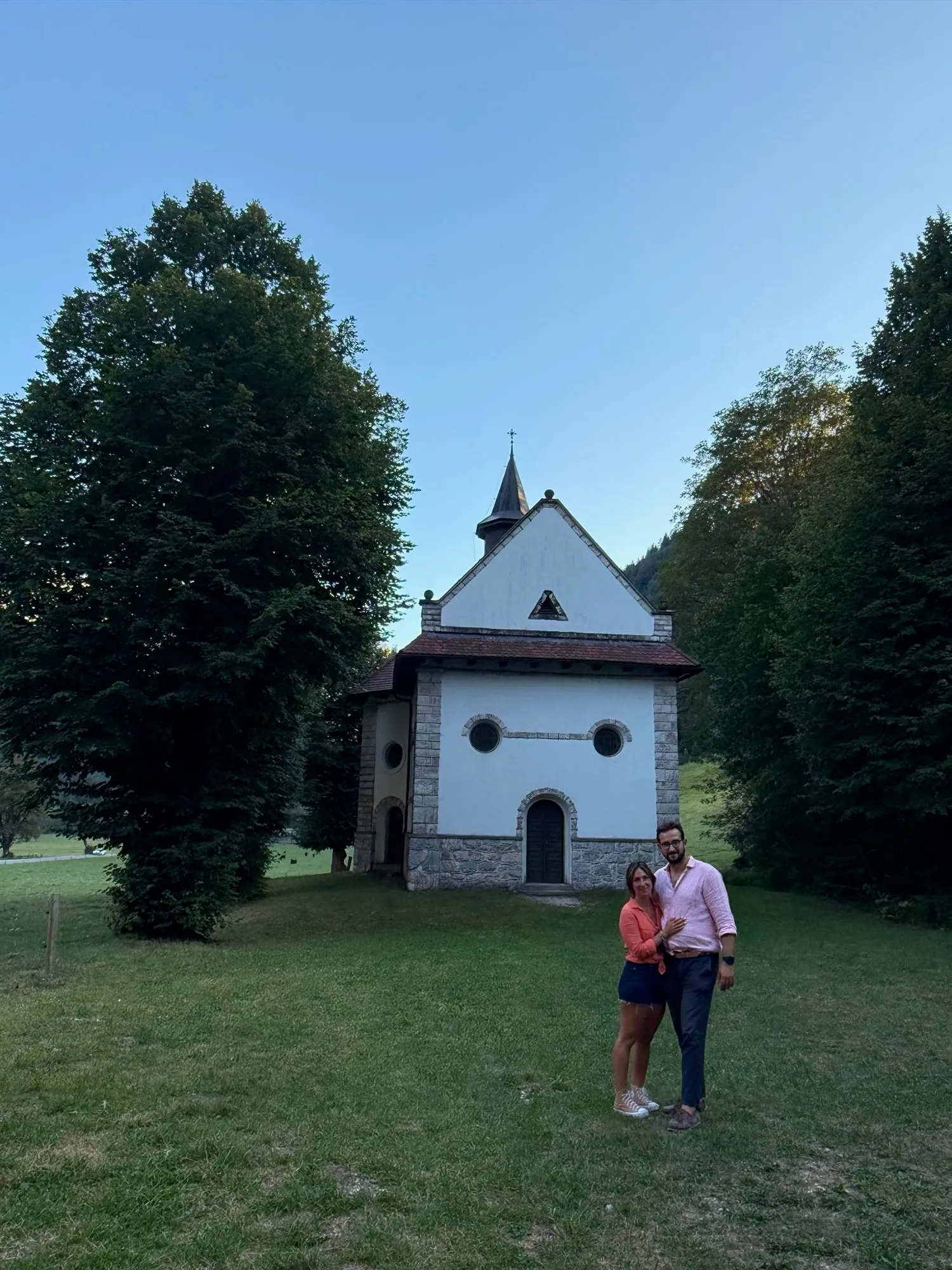 Alejandra and Urban by the chapel in Logarska Dolina at dusk