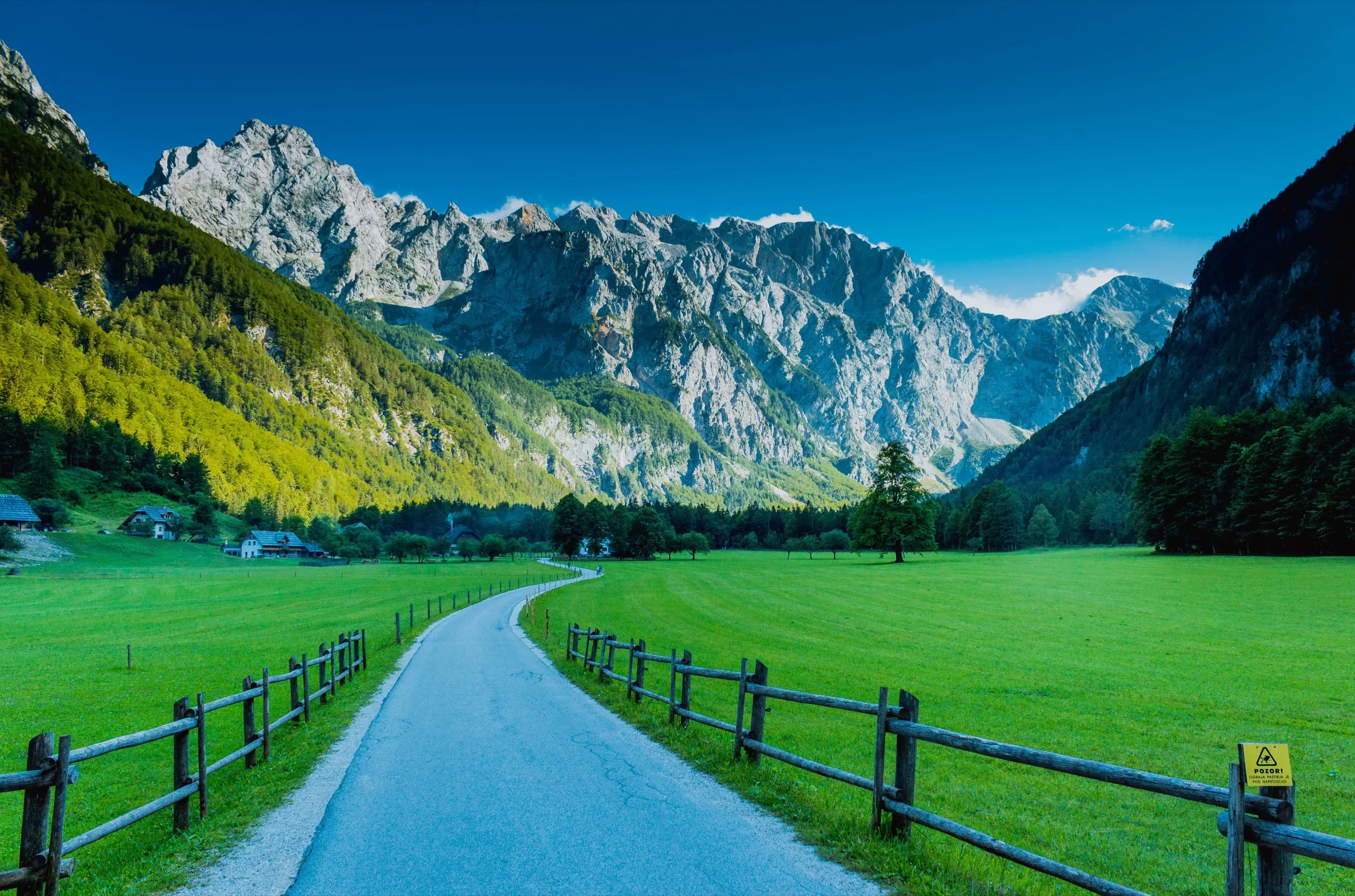 The road into Logarska Dolina, with the limestone wall of the Kamnik–Savinja Alps beyond